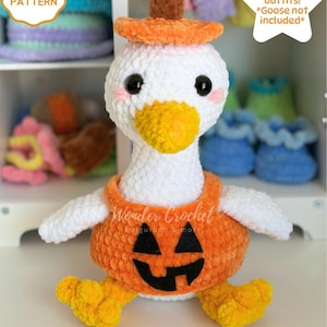 May include: A white crochet goose plushie wearing an orange pumpkin-shaped outfit with a black jack-o'-lantern face and a matching orange hat with a brown stem. The text CROCHET PATTERN, 8 Seasonal outfits! *Goose not included*, and DIGITAL DOWNLOAD appear.