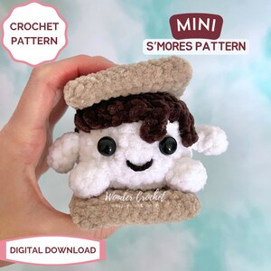 K&ouml;nnte beinhalten: Ein geh&auml;keltes Amigurumi-S'more mit einer braunen Schokoladen-Schicht, einem wei&szlig;en Marshmallow und zwei Graham-Cracker-Schichten. Das S'more hat ein l&auml;chelndes Gesicht mit schwarzen Augen. Der Text "MINI S'MORES PATTERN" und "Wonder Crochet" ist auf dem Bild zu sehen.