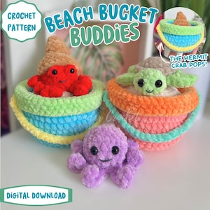 May include: A crochet pattern for "Beach Bucket Buddies" is shown. The image features three colorful, plush beach buckets with smiling sea creature characters. The buckets are filled with a red crab, a green turtle, and a purple octopus. The text "Digital Download" is visible.