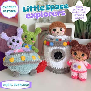 May include: A crochet pattern digital download titled Little Space explorers featuring plush toys including a light purple three-eyed alien in a blue flying saucer, a green alien, a brown-haired astronaut in a white rocket, and a brown-haired astronaut.