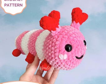 Peut inclure: Patron de crochet pour un amigurumi rayé rose et blanc avec des oreilles en forme de cœur rouge. L'amigurumi a un visage souriant avec des yeux noirs et un nez blanc. Le patron est un téléchargement numérique.