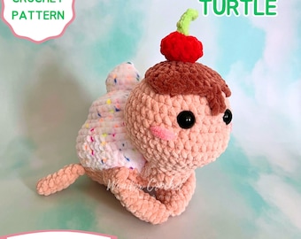May include: Crochet pattern for an ice cream turtle amigurumi. The turtle is pink with a brown chocolate ice cream shell and a red cherry on top. The pattern is available for digital download.