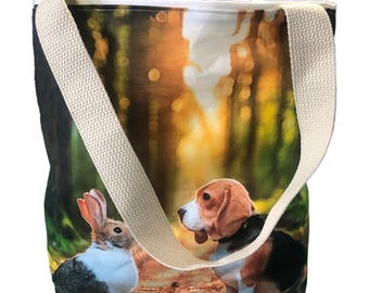 May include: A beige canvas tote bag with a printed image of a beagle dog and a rabbit in a forest setting. The bag has two long beige straps.