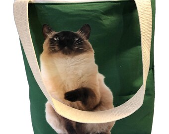 May include: A green canvas tote bag with a white strap and a printed image of a Siamese cat sitting up.