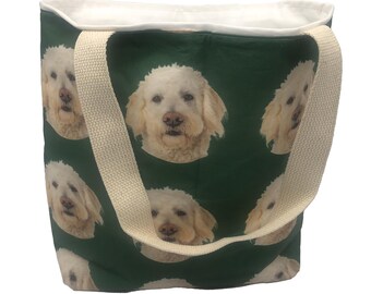May include: A green canvas tote bag with white straps. The bag is printed with a repeating pattern of a white dog's face.
