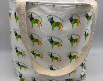 May include: White canvas tote bag with a repeating pattern of colorful Australian Cattle Dog silhouettes and the text "Aussie Cattle Dog Mom".