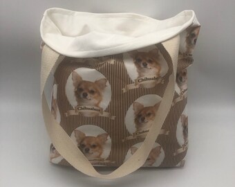 May include: A white canvas tote bag with brown straps. The bag is printed with a pattern of brown stripes and circles featuring images of Chihuahua dogs with the word "Chihuahua" printed below each dog.