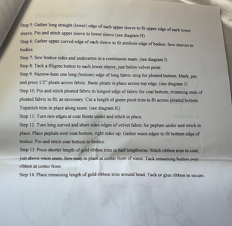 May include: A close-up of a printed page with sewing instructions. The text details steps for garment construction, including gathering sleeves, attaching buttons, and pleating fabric. The instructions are numbered and detailed.