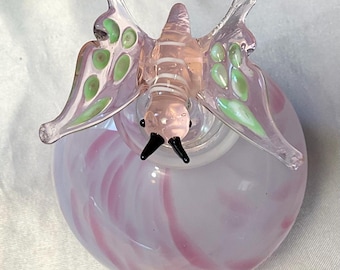 Gorgeous Vintage art glass perfume bottle with a charming pink and white swirl, opalescent finish,  topped with a glass Butterfly