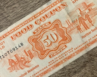 May include: A vintage US Department of Agriculture food coupon with the text "Food Coupon" and a value of "50 cents". The coupon has a red and white design with a picture of a farm and a family.