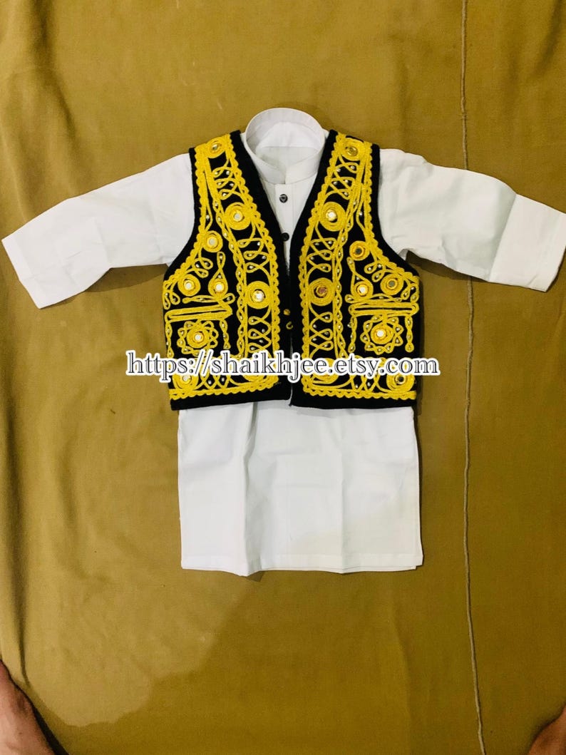 May include: A traditional outfit for children, featuring a white shirt and a black vest with yellow embroidery and mirror accents. The outfit is designed with a classic style, perfect for cultural events.