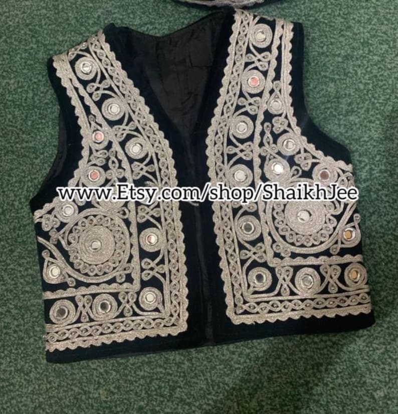 May include: Black vest with intricate silver embroidery and small mirrored accents. The vest features a V-neck design and is embellished with detailed patterns. The Etsy shop URL is visible on the image.
