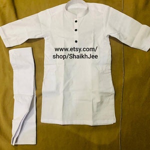 May include: White kurta pajama set. The top has a mandarin collar and three black buttons. The text "www.etsy.com/shop/ShaikhJee" is printed on the image. The set is made of a lightweight fabric.