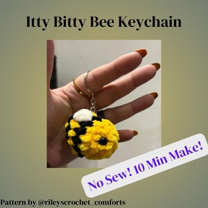 May include: A crocheted bee keychain with black and yellow stripes, white wings, and black bead eyes. The keychain is attached to a silver ring. The text "No Sew! 10 Min Make!" is in the image.