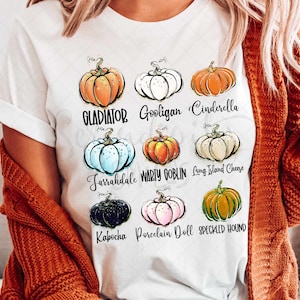 May include: White t-shirt with a graphic of nine pumpkins with names like Gladiator, Gooligan, Cinderella, Jarrahdale, Warty Goblin, Long Island Cheese, Kabocha, Porcelain Doll, and Specialed Hound.