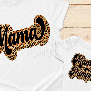 May include: Two white t-shirts with a leopard print design. The larger shirt says "Mama" in black text. The smaller shirt says "Mama's Pumpkin" in black text.