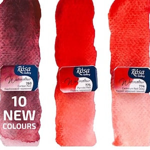 May include: Three watercolour paint tubes in shades of red. The tubes are labelled with the brand name "R&oacute;sa Gallery" and the colour names "Carbon Red", "Pyrrole Red", and "Cadmium Red Deep".