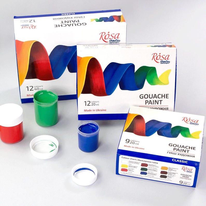 May include: A set of gouache paint in 12 colors, with a red, white, and blue swirl design on the box. The paint comes in small, round jars with white lids. The box is labeled "Gouache Paint" and "R&oacute;sa Studio".