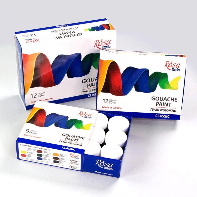May include: A set of 12 gouache paint tubes in white containers. The tubes are arranged in a circle on a white surface. The paint tubes are labeled "Gouache Paint" and "Rosa Studio". The paint tubes are made in Ukraine.