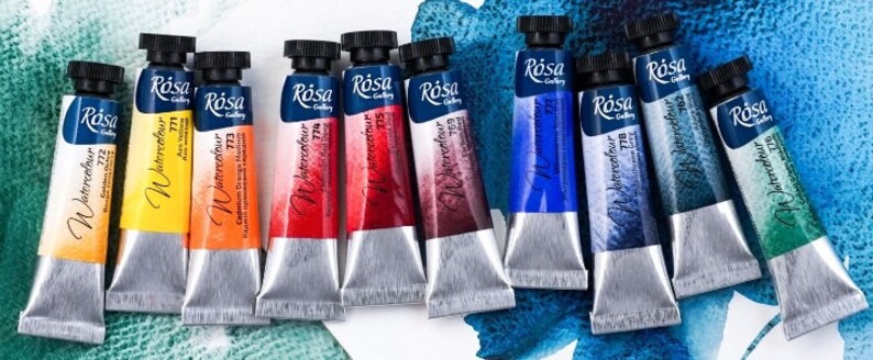 May include: A set of ten watercolor paint tubes in various colors, including yellow, orange, red, brown, blue, green, and black. The tubes are labeled "R&oacute;sa Gallery Watercolor" and have a silver finish.