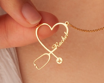 May include: Gold necklace with a heart-shaped pendant featuring a stethoscope and the name "Rachel".