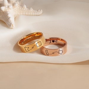 May include: Two gold rings with engraved state outlines and the text "My Love, Always" and "J & C" on the bands.