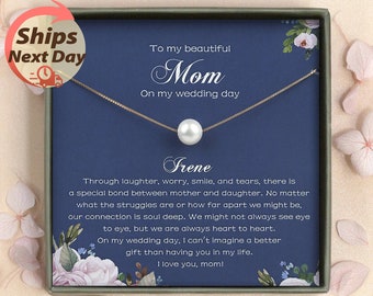 May include: A gold-toned necklace with a single white pearl pendant, presented in a gift box with a navy blue background. The box includes text that reads "To my beautiful Mom On my wedding day" and a personalized message.