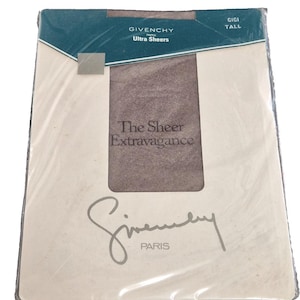 May include: A package of Givenchy Ultra Sheers tights. The packaging is off-white with a teal blue accent at the top. The text "GIVENCHY PARIS Ultra Sheers" is printed on the package. The words "The Sheer Extravagance" are also visible.