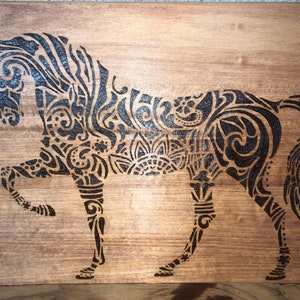 Wood burned Celtic animal sign - horse, elephant or giraffe.