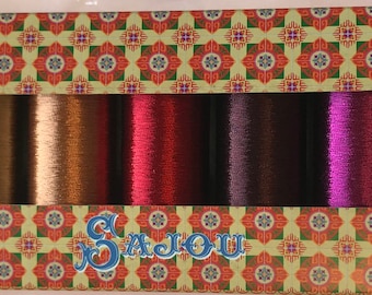 May include: A box of 12 spools of embroidery floss in various colors, including green, blue, purple, red, orange, yellow, and brown. The box has a floral pattern and the text "G. Badou" on the front.