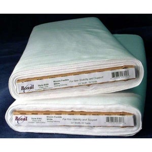 May include: Two rolls of white woven fusible fabric, labeled "Bosal," for sewing and tailoring. Each roll is 23 inches wide and contains 25 yards of 100% cotton fabric, providing firm stability and support for various projects.