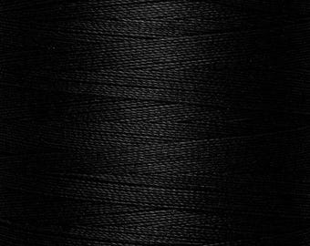 May include: A close-up view of a spool of black thread, showing the fine, tightly wound horizontal fibers that create a consistent, smooth texture across the entire surface of the spool, highlighting the deep, solid black color of the material.