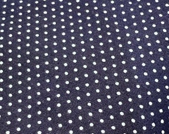 May include: A dark blue fabric with a white polka dot pattern.