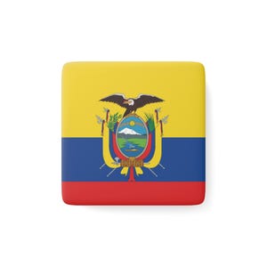 May include: A square item displaying the flag of Ecuador. The flag is divided into three horizontal bands: yellow at the top, blue in the middle, and red at the bottom. The Ecuadorian coat of arms is in the centre.