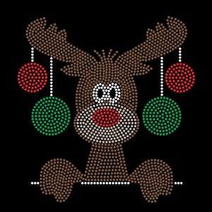 May include: A rhinestone transfer design on a black background featuring a brown reindeer with a red nose and white eyes. The reindeer has large antlers decorated with hanging red and green circular ornaments. The design is finished with a white line.
