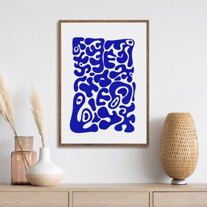 May include: A framed abstract print with a blue and white design. The print features a variety of organic shapes and forms, creating a modern and stylish look.