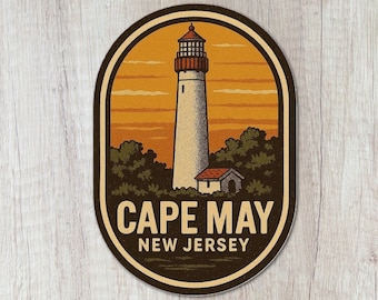 May include: An oval sticker featuring a tall lighthouse with a red top, set against a golden orange sunset sky. Dark green trees surround the base of the lighthouse and a small building. The text CAPE MAY NEW JERSEY is printed in bold letters.