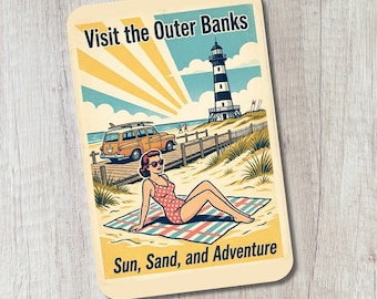 May include: A rectangular sticker featuring a vintage-style illustration with the text Visit the Outer Banks and Sun, Sand, and Adventure. It depicts a person in a red polka-dot swimsuit sitting on a plaid blanket on a sandy beach near a lighthouse and a yellow station wagon.