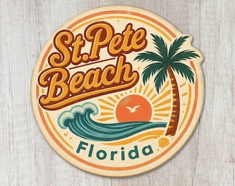 May include: A circular coaster featuring a retro-style graphic with the text St. Pete Beach Florida. The design includes a dark green palm tree, a stylized orange sun, a teal ocean wave, and a small white bird against a cream-colored background.