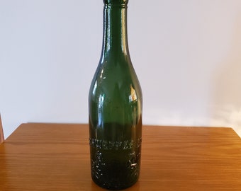 Vintage Schweppe's dark green bottle with lions and crest