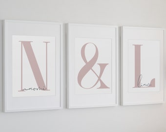 May include: Three framed prints with the letters N, & and L in a dusty rose color. The names Naomi and Liam are written in cursive below the letters.