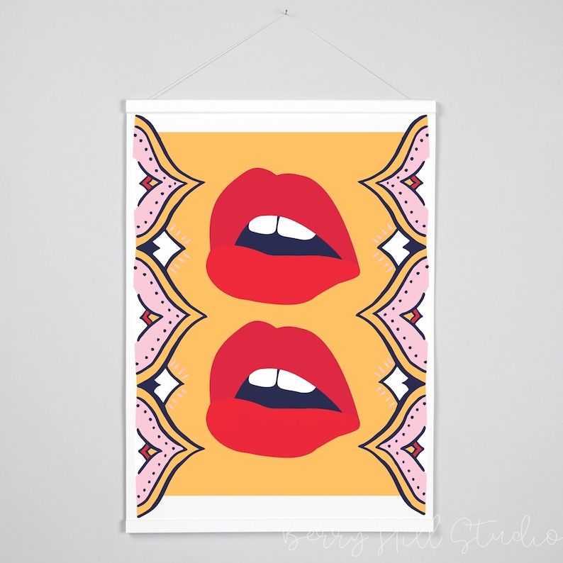 May include: A digital illustration of two pairs of red lips with white teeth on a yellow background. The lips are framed by a pink and blue patterned border.