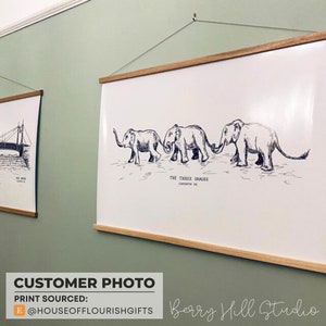 May include: A black and white illustration of three elephants walking in a line. The elephants are drawn in a simple style and the illustration is titled "The Three Graces".