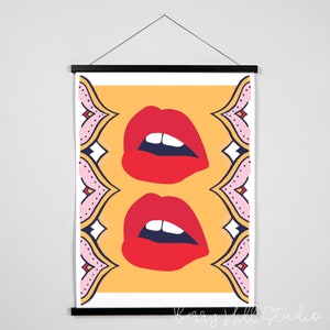 May include: A digital illustration of two red lips with white teeth on a yellow background. The lips are framed by a pink and blue patterned border.