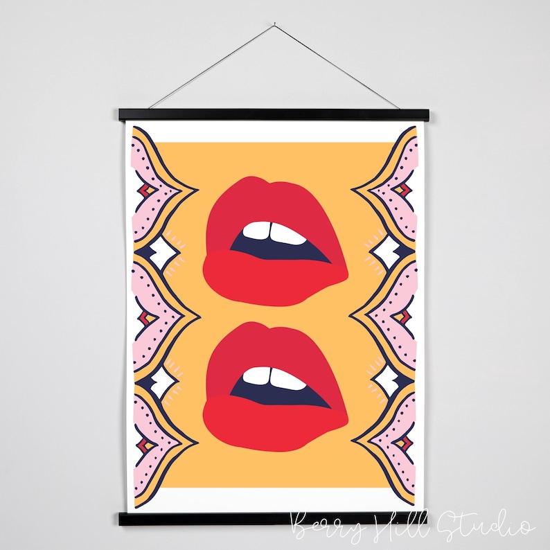 May include: A digital illustration of two red lips with white teeth on a yellow background. The lips are framed by a pink and blue patterned border.