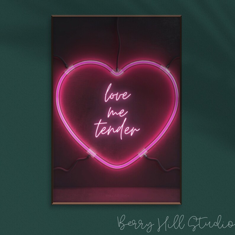 May include: A pink neon heart-shaped sign with the words "love me tender" inside. The sign is on a dark red background.