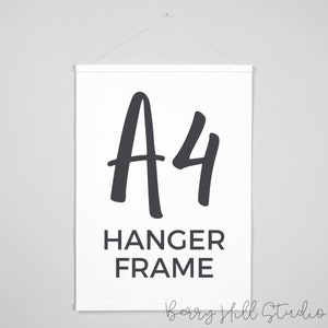 May include: A white poster with a black hanger frame. The poster has the text "A4 HANGER FRAME" in black.