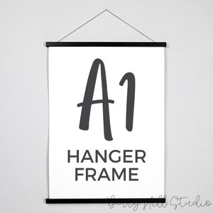 May include: An A1 Hanger Frame, a black poster hanger frame with a white poster featuring the text "A1 Hanger Frame" in black.