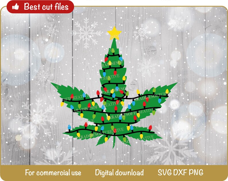 May include: A green marijuana leaf with a star on top, decorated with colorful Christmas lights. The leaf is on a woodgrain background with snowflakes.