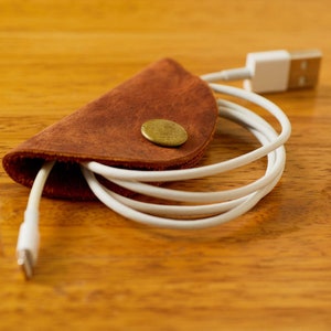 Leather Cord Taco | cord keeper technology accessories cable tie travel work style work from home organization tech gift recycled leather